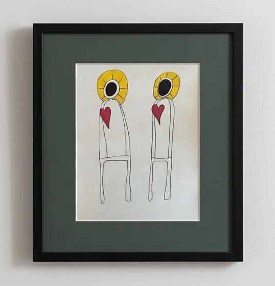 No. 99. Two slender figures with golden halos and red hearts on pale paper, displayed in a dark green mat and black frame.