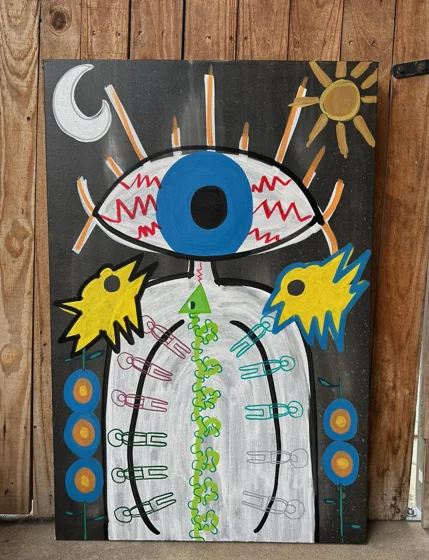 Third Eye Arrives. A large blue eye floats above a white figure with a green spine, between yellow birds beneath a sun and crescent moon.