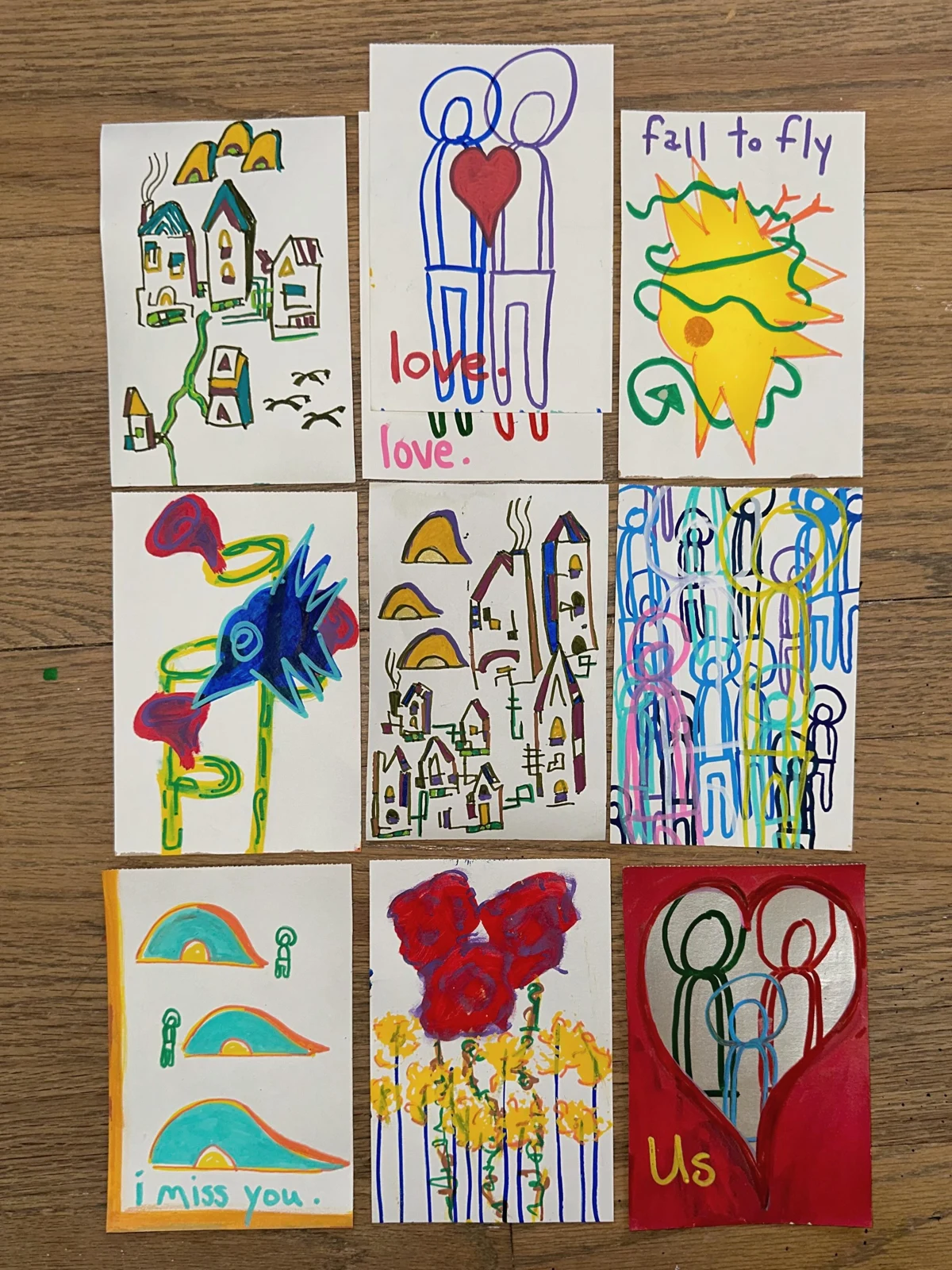 Postcards — Series 1. Nine hand-painted postcards arranged in a grid, featuring houses, figures, hearts, birds, and short handwritten messages.